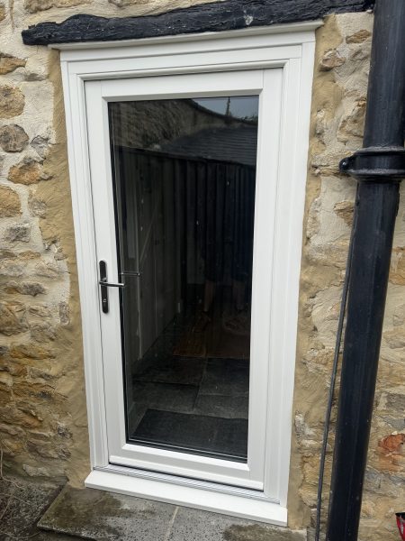 New uPVC door installed on a stone cottage in Sherborne