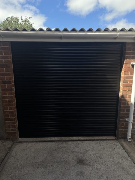 Black electric roller garage door installed in Gillingham, Dorset