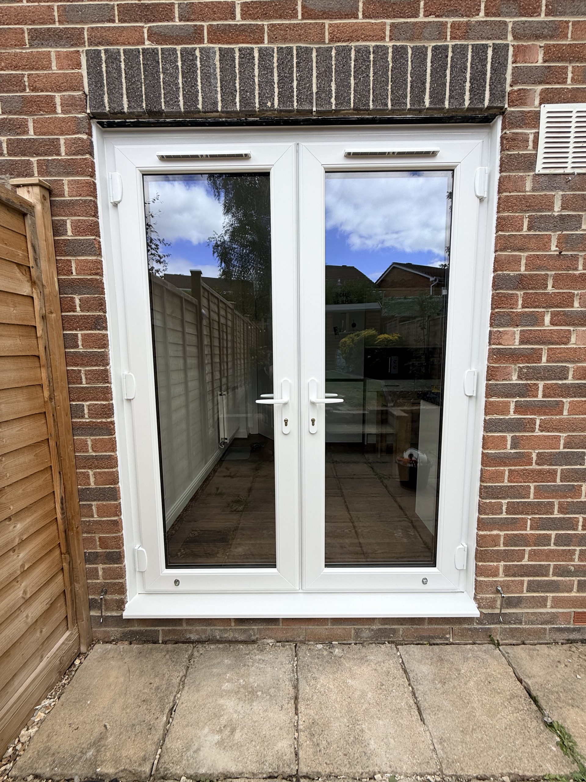 New white uPVC French doors installed in Gillingham, Dorset by Goldhill Glazing.