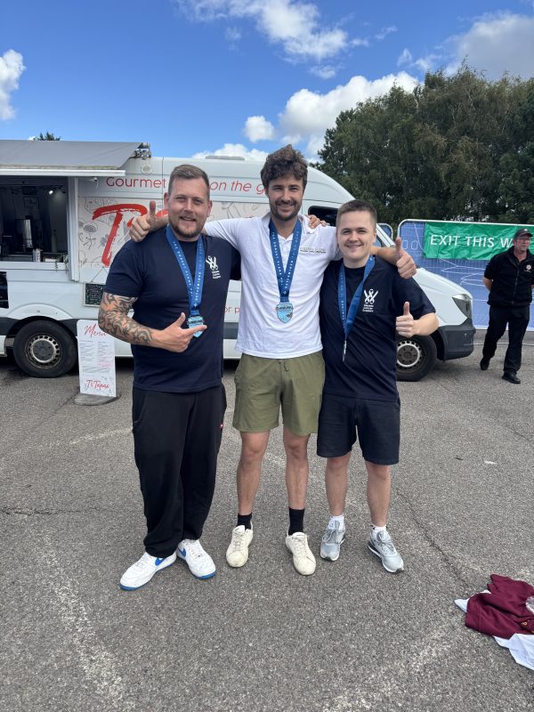 Kyle, Kenny and Liam from Goldhill Glazing with their medals at the Dorset Plane Pull for Wessex Cancer Support